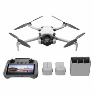 Compact drone with camera, remote controller, batteries, and charging hub.