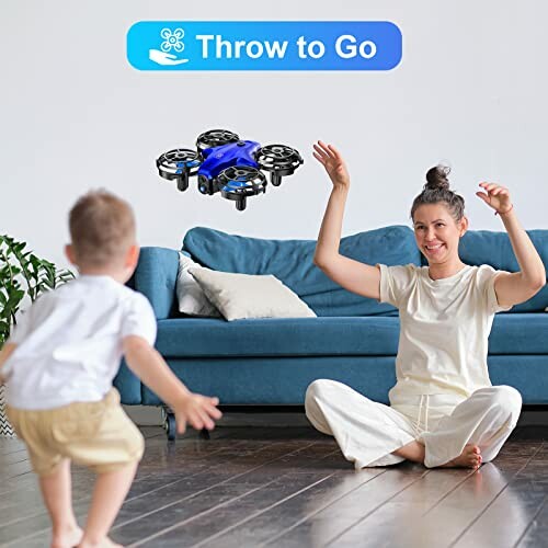 Woman and child playing with a small drone indoors.