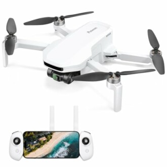 White drone with camera and remote controller displaying aerial view.